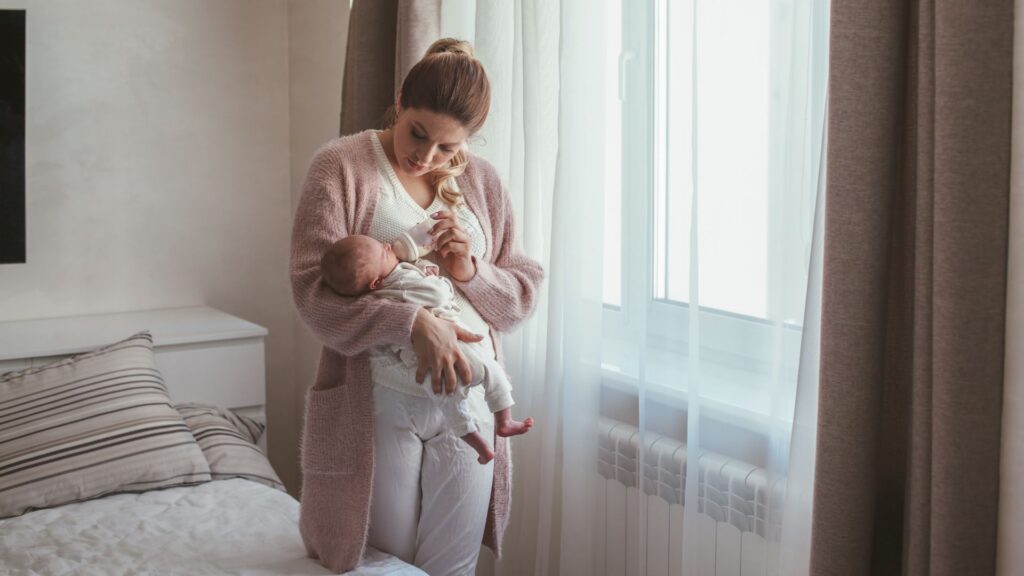 Mom holding baby and giving a bottle